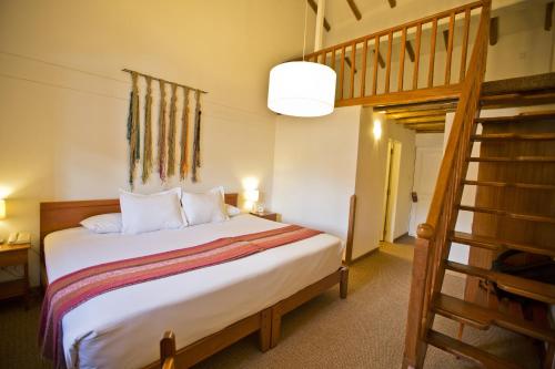 a bedroom with a bunk bed and a ladder at Tierra Viva Cusco Centro in Cusco