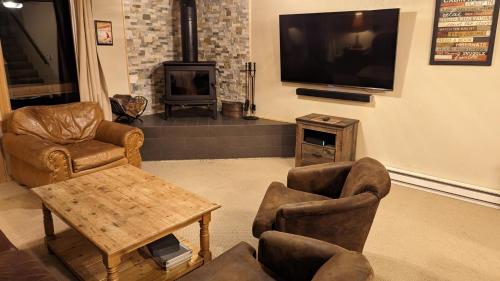 a living room with furniture and a tv and a fireplace at Cozy Townhouse on the main bus line in Breckenridge