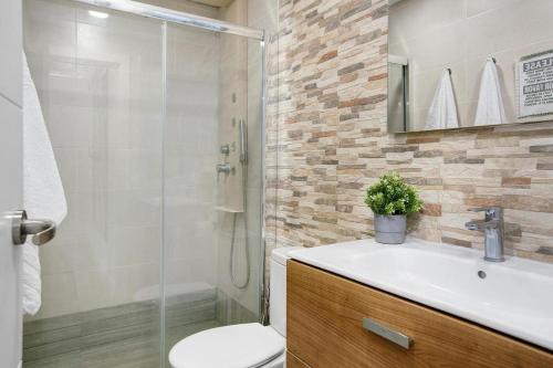 a bathroom with a shower and a sink and a toilet at Villa Luxury Las Mesas in Las Palmas de Gran Canaria
