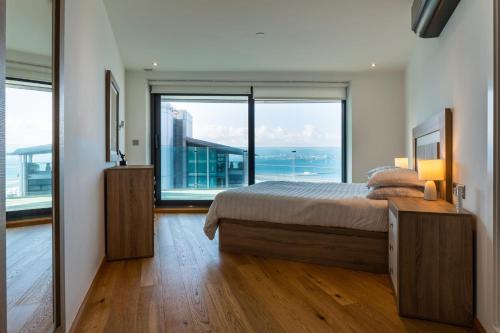 a bedroom with a bed and a large window at OCEAN Plaza Suite 07-Hosted by Sweetstay in Gibraltar