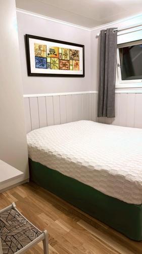 a bedroom with a bed in a room with a window at Leilighet for korttidsleie in Otta