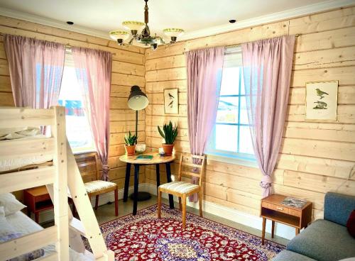 Schlafzimmer mit einem Bett, einem Schreibtisch und einem Tisch in der Unterkunft Scenic small guesthouse on horse farm by the lake in Frösö