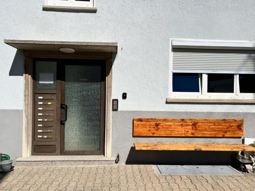 a building with a wooden bench next to a door at *Wohnung NELE* einzigartig in VS mit Parkplatz in Villingen-Schwenningen