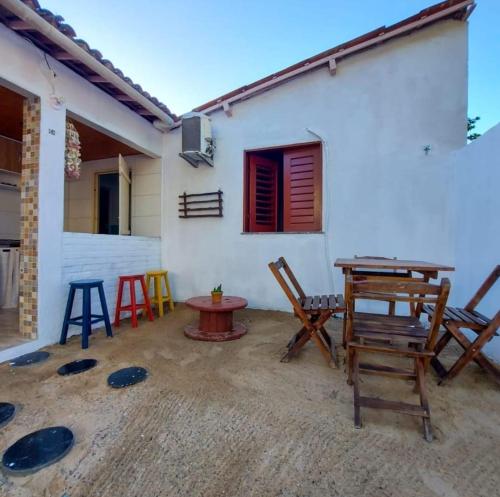 a patio with chairs and a table in front of a house at Na Casa Delas Jeri - com Churrasqueira in Jericoacoara