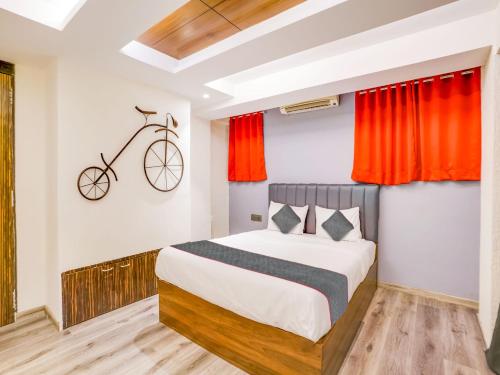 a bedroom with a bed and a bike on the wall at Sairup Stays in Navi Mumbai