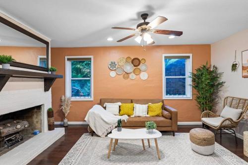 a living room with a couch and a ceiling fan at Cozy suite in Buckhead/Midtown + free parking in Atlanta