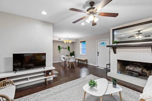 a living room with a fireplace and a ceiling fan at Cozy Buckhead Suite - great area, free easy parking, near shops and restaurants in Atlanta
