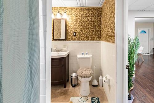 a bathroom with a toilet and a sink at Cozy suite in Buckhead/Midtown + free parking in Atlanta