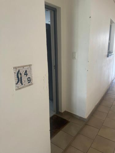 an empty room with a door and a tile floor at Dream Abodes @ SPLICE RIVIERA in Johannesburg