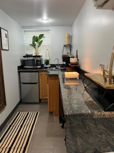 a kitchen with a sink and a counter top at Chicago - Pilsen Studio apartment - Unit B in Chicago