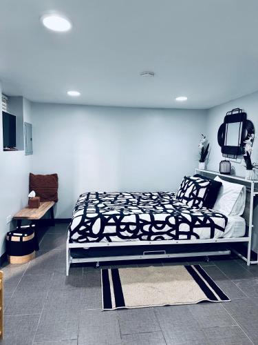 a bedroom with a bed with black and white sheets at Chicago - Pilsen Studio apartment - Unit B in Chicago