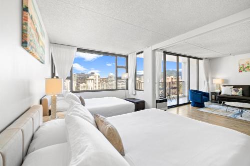 a hotel room with two beds and a large window at Ocean View Suite, Near Beach & Free Parking! in Honolulu