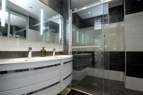 une salle de bain avec deux lavabos et une douche dans l'établissement Isadora, à Cannes