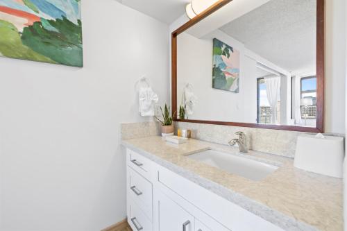 a bathroom with a sink and a large mirror at Ocean View Suite, Near Beach & Free Parking! in Honolulu