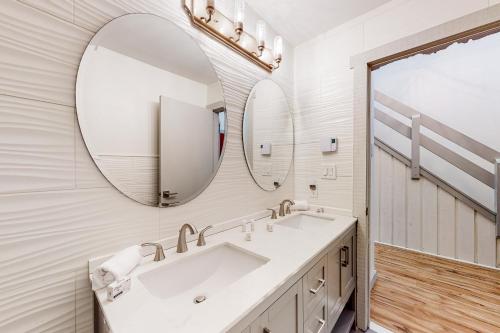 Baño blanco con lavabo y espejo en Red Fox Home, en Lake Harmony