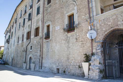 a stone building with a sign on the side of it at Palazzo Tronconi agriturismo in Arce