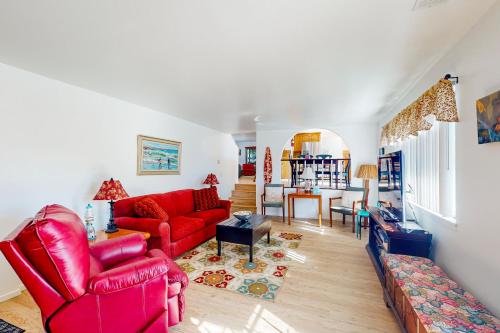 a living room with red chairs and a red couch at Hazel Eyes in Nipomo