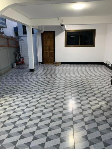 an empty room with a checkered floor at Udon House in Udon Thani