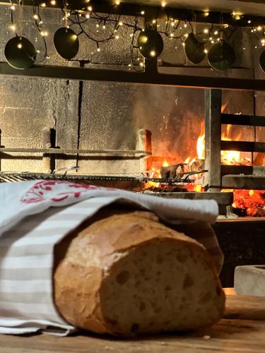 a loaf of bread in front of a fire at B&B Al Felcino in Fabro