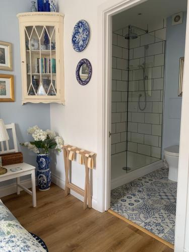 a bathroom with a shower with a glass door at Esme's in Winchester