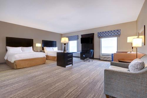a hotel room with two beds and a desk at Hampton Inn & Suites Tampa Northwest/Oldsmar in Oldsmar