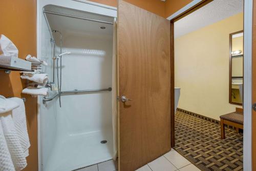a bathroom with a shower stall and a door at Quality Inn Ashland in Ashland