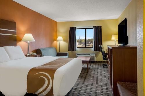 a hotel room with a bed and a television at Quality Inn Ashland in Ashland