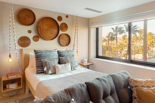 a bedroom with a bed with wooden plates on the wall at CS Downtown Loft CSL in Cabo San Lucas