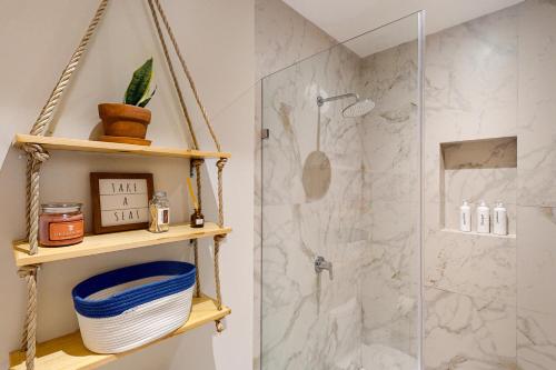 a bathroom with a shower with a glass door at CS Downtown Loft CSL in Cabo San Lucas