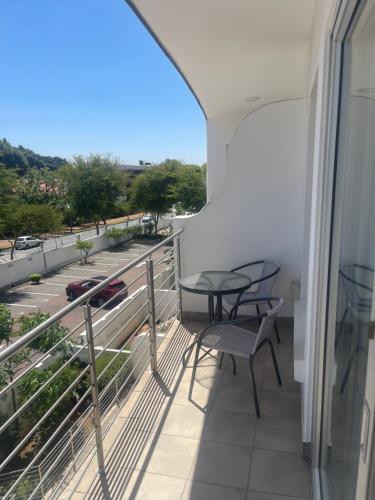 a balcony with a table and chairs and a view at Dream Abodes @ SPLICE RIVIERA in Johannesburg