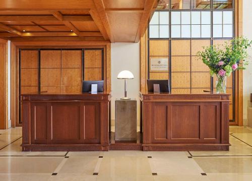 a lobby with two podiums and a vase of flowers at NH Collection A Coruña Finisterre in A Coruña