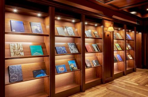 a book shelf with many books on it at NH Collection A Coruña Finisterre in A Coruña