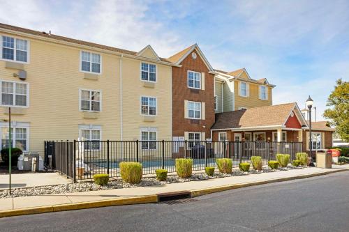 a house with a fence in front of a street at MainStay Suites Mt Laurel - Philadelphia in Mount Laurel
