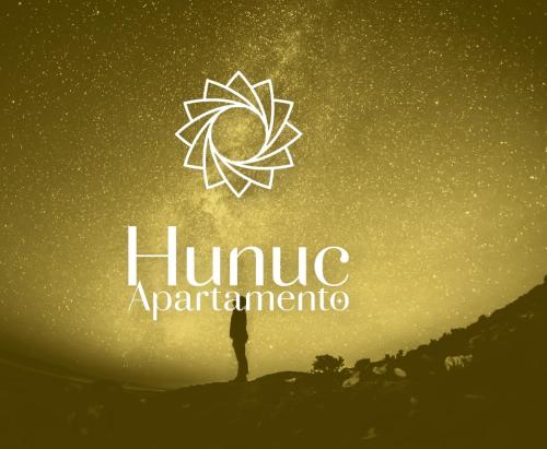 a person standing on top of a hill with the sun at Hunuc apartamento in Rivadavia