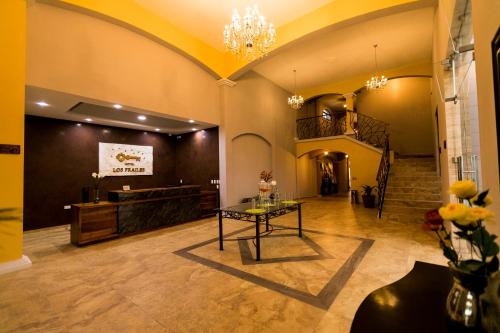 a lobby with a table in the middle of a room at Hotel Los Frailes, Valladolid, Yucatán in Valladolid