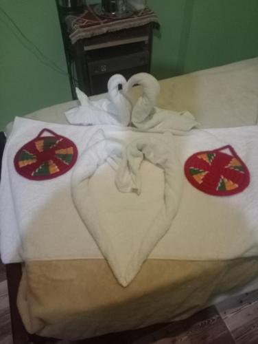 two swans making a heart on a bed at NeNeKaTo Nubian House in Aswan