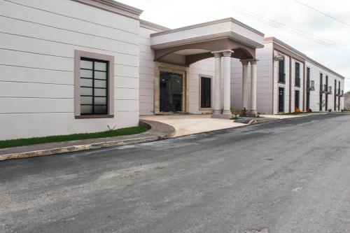 an empty street in front of a white building at Hotel Los Frailes, Valladolid, Yucatán in Valladolid