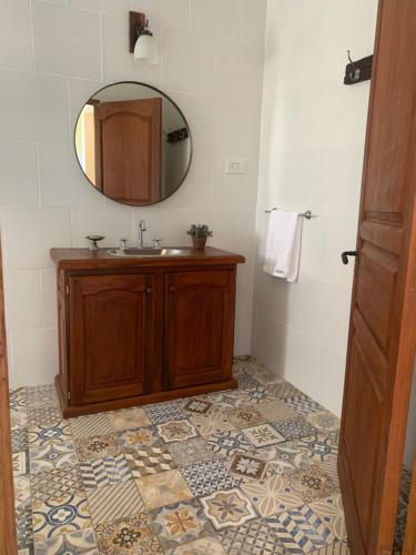 a bathroom with a sink and a mirror at El Hornero in San Andrés de Giles