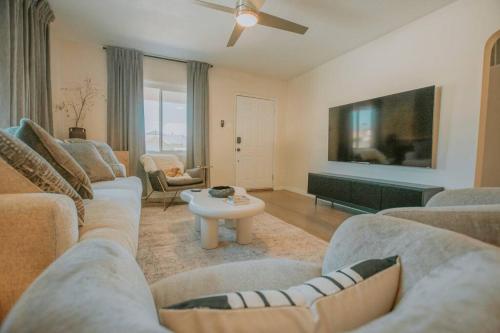 a living room with two couches and a table at Casa Urbana-Close to Downtown-Hot Tub-Pet Friendly-No Pet Fees! in Albuquerque