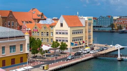 a view of a city with a river and buildings at Punda City Centre Penthouse in Willemstad