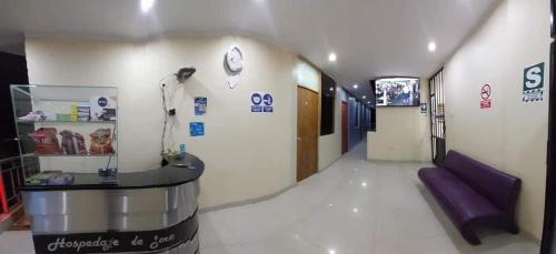 a hospital hallway with a purple couch in a room at Hospedaje de Joce in Nazca