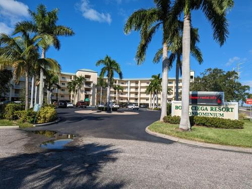 a street in front of a hotel with palm trees at Boca Ciega Resort in St. Petersburg