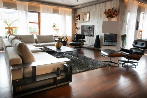 GarðabærにあるSea View Villaのリビングルーム(大きなソファ、椅子付)
