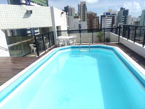 a swimming pool on the roof of a building at Apto imperial Cabo branco in João Pessoa