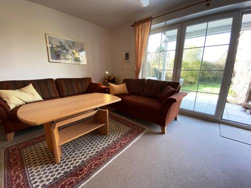 a living room with a couch and a table at Seehund in Schönberger Strand