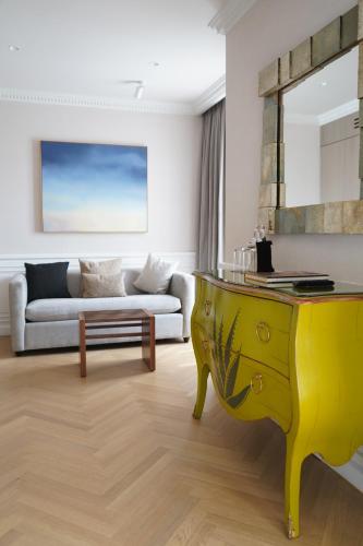 a living room with a yellow table and a couch at The Alest Hotel in Mexico City