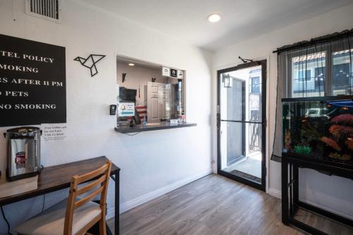 a dining room with a table and a window at Unik Motel in Harbor City