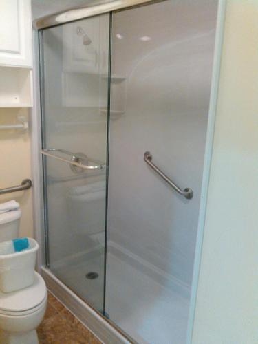 a glass shower in a bathroom with a toilet at Ocean Walk Resort - Fabulous Ocean Front View in Daytona Beach