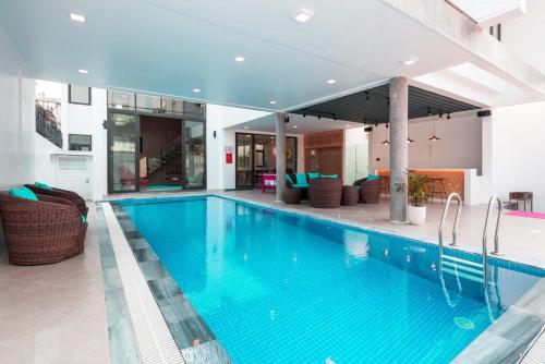 a large swimming pool with blue water in a building at Luxury Beach Villa Da Nang in Da Nang