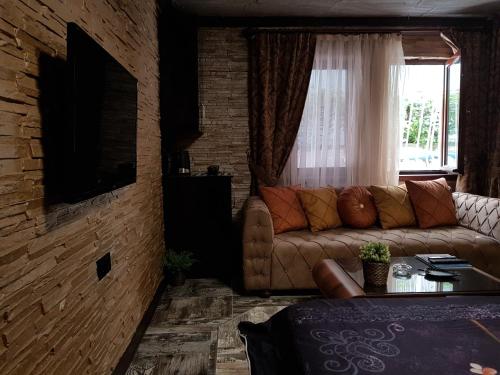 a living room with a couch and a window at Elegant House Otel in Ankara